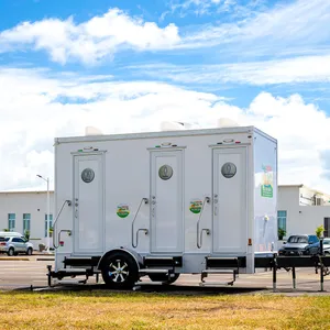 Island Sanitation Plus AC restroom trailer set up in a parking lot for an event