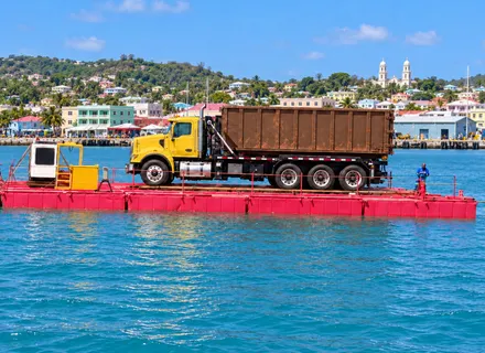 Island Sanitation Plus truck and equipment barge in St. John’s Harbour, Antigua